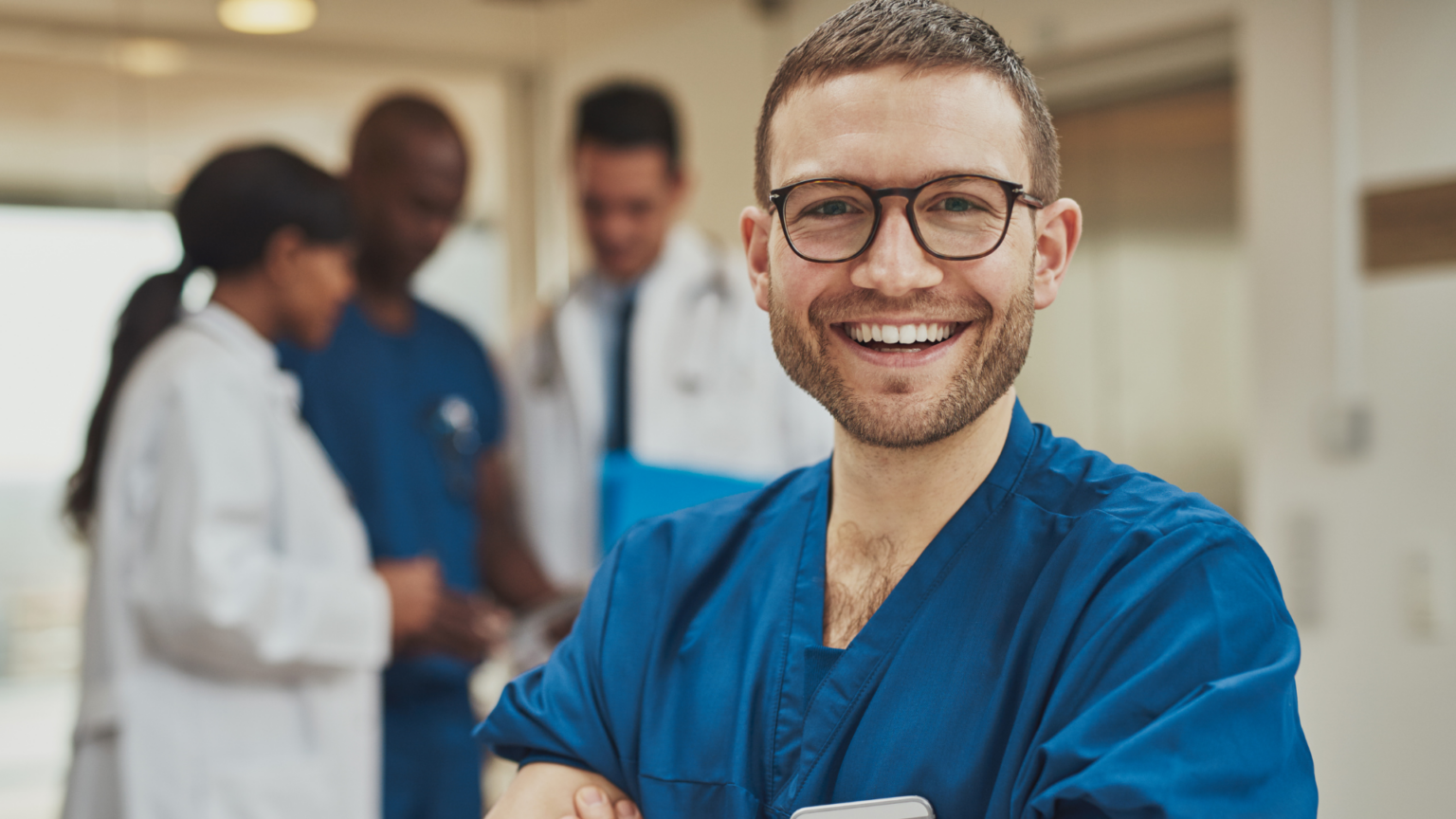 Artfully Media - Recruitment Advertising Made Simple Improve job advertising ROI without additional spend - Healthcare recruitment, picture of a man wearing hospital scrubs.